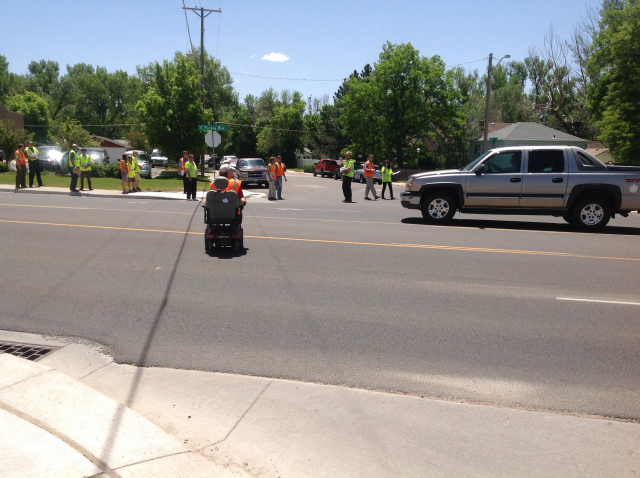 A person crossing in a wheel chair almost got hit by a speeding vehicle. There are no pedestrian crossing signs or safe islands.