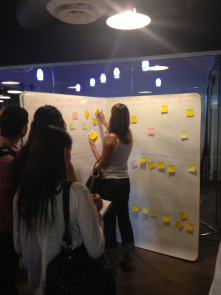 Participants crowd around the Big Book during the Manifesto Project at CO+HOOTS.