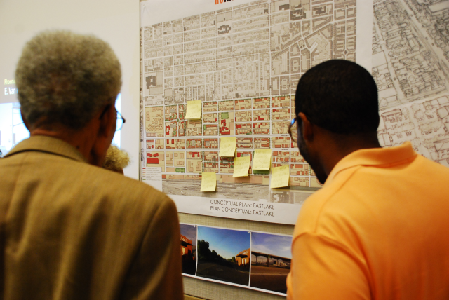 Community members gather to read other resident ideas and comments that were placed on the presentation boards.