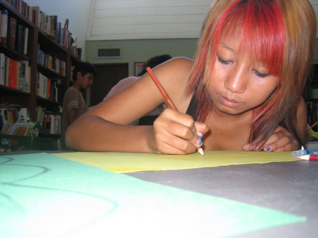 Thoughtfully drawing her ideal neighborhood park full of shade and water!
