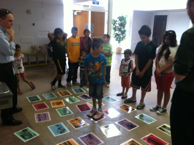 Children at the Amigos Center playing the Road to Downtown game