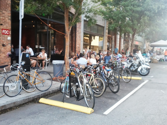 Turning underutilized space into bike parking, pedestrian zones, buffered bike lanes and/or parklets.