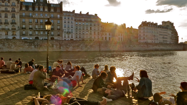 People relaxing on the banks of the Seine in Paris. On this day (a holiday) people flocked to the open spaces in the city. 