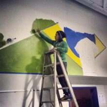 Painting a futbol mural at Paparruchos indoor soccer facility where adults and kids gather to play everyday.