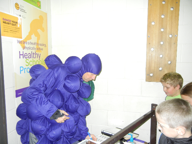 Dr. Chaussee dresses like a grape as part of the incentive for Grace Abbott's fundraiser.  The Abbott families raised over $13,000.