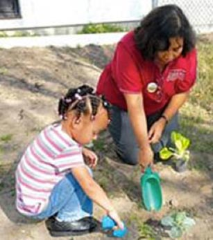 Children helping plant gardens for seniors last fall.