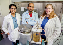 Indian scientist (center) who invented the machine that converts plastics back into usable gasoline.