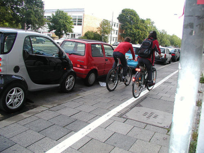 Place bike lanes in between sidewalks and parked cars